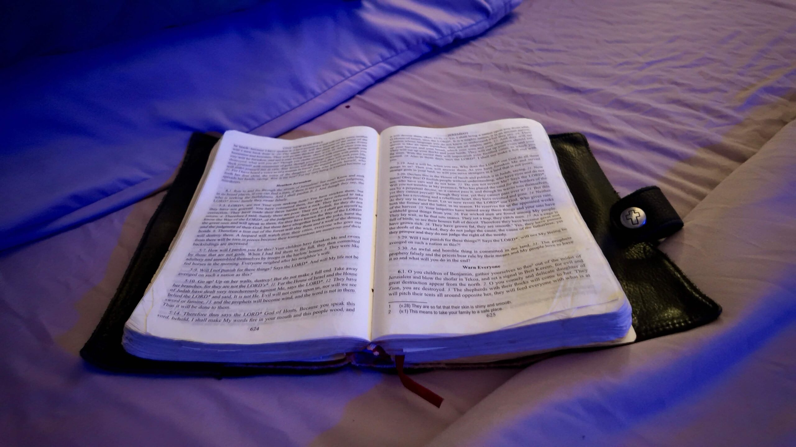 Open Bible on a bed